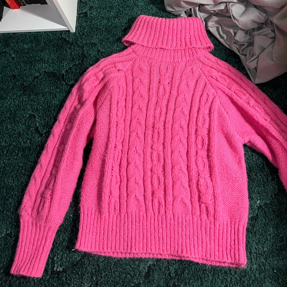 Hot pink, cable knit sweater.